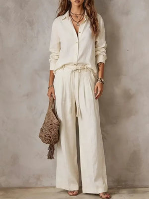 Woman in off white long sleeve shirt and wide leg pants set with braided tie belt, full length