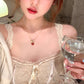 Gold tone beaded chain and red heart pendant of the adjustable necklace shown in full