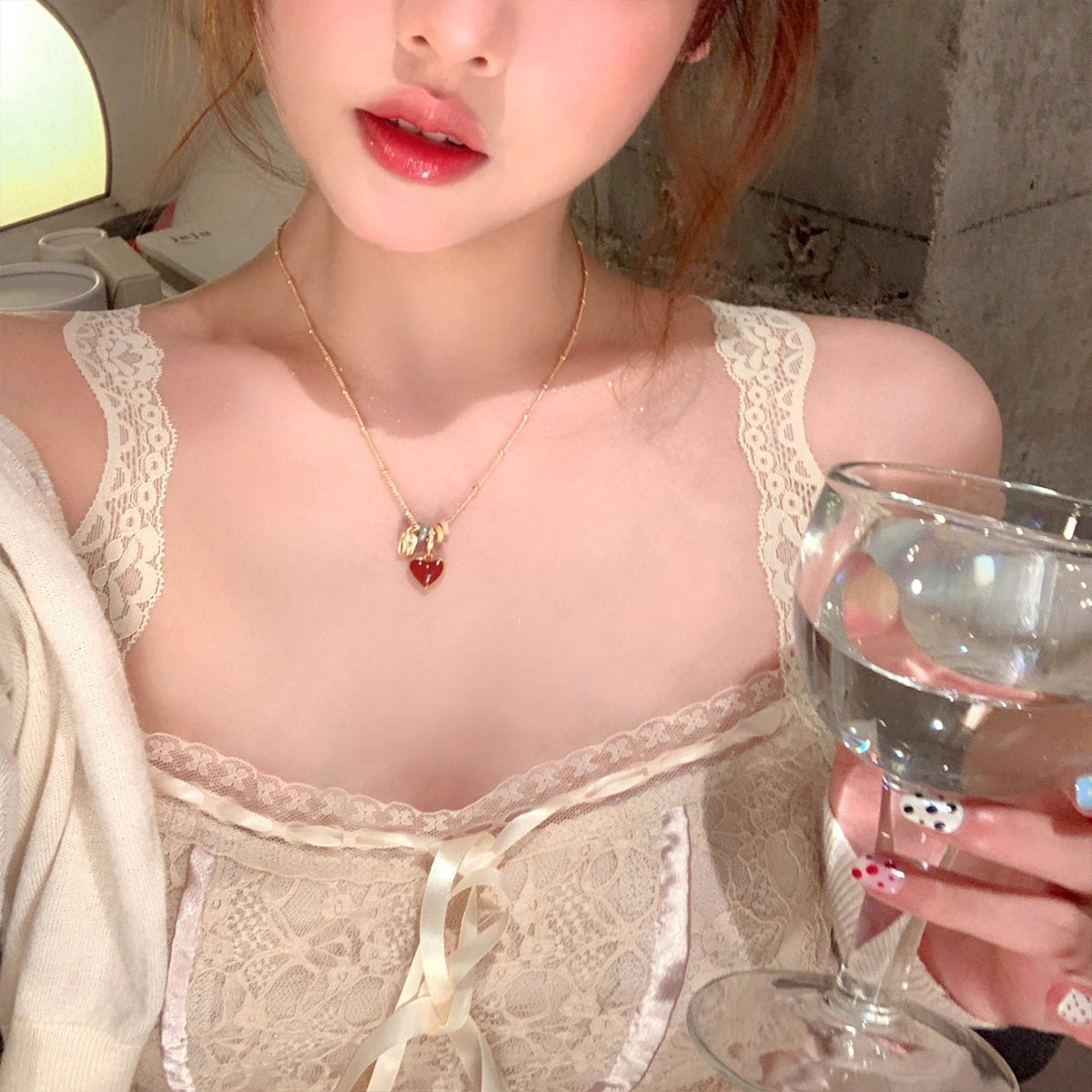 Gold tone beaded chain and red heart pendant of the adjustable necklace shown in full