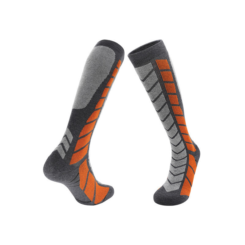 Thick knit ski socks with an arrow pattern up the shin and a padded footbed on white