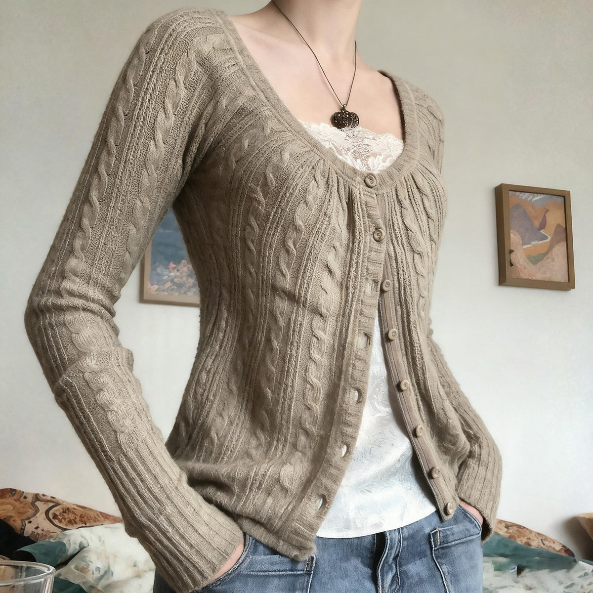 Side view of the khaki cable knit cardigan with long raglan sleeves and a ribbed cuff