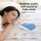 Bedside scene with a blue pillow speaker resting on a duvet beside a sleeper