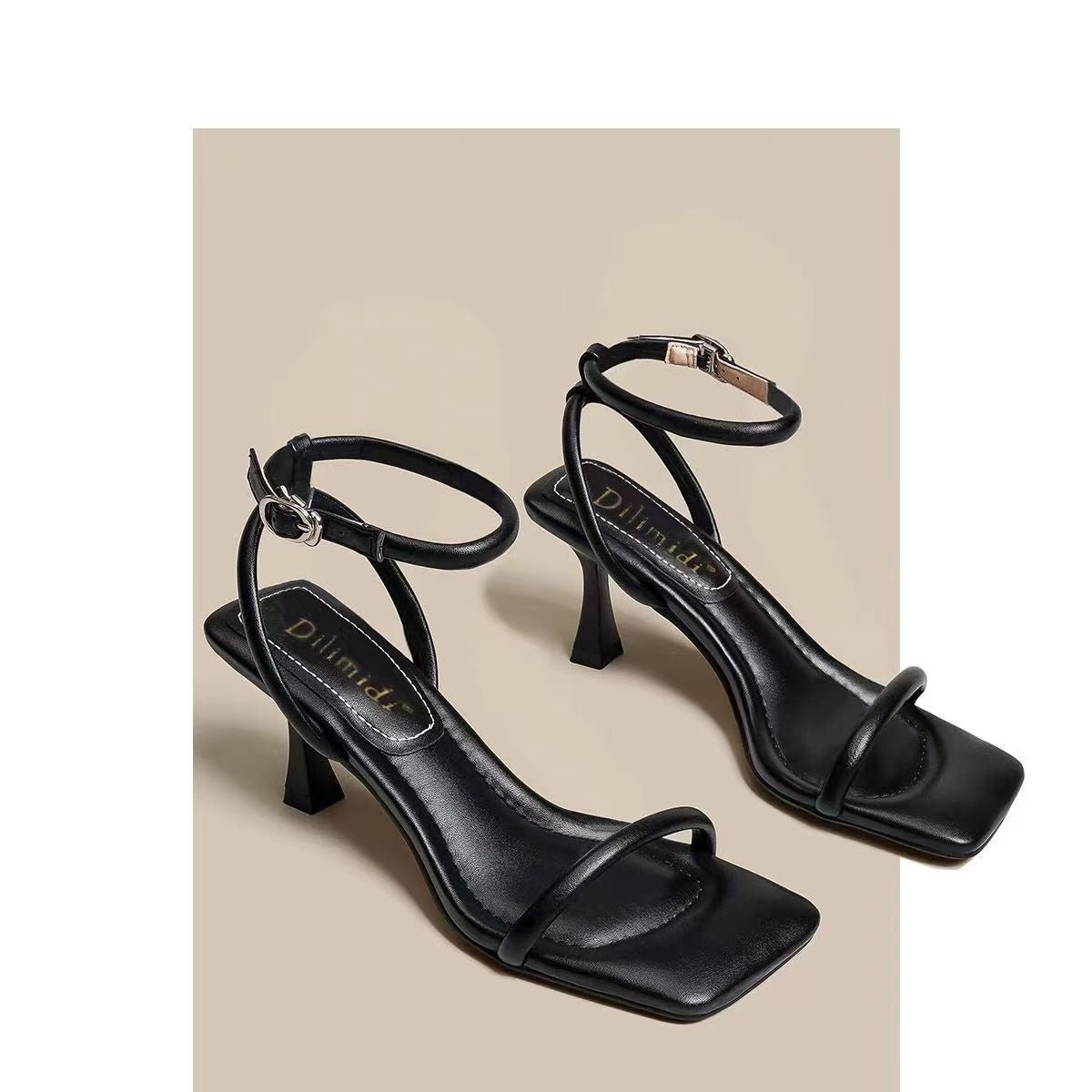 Pair of black square toe ankle strap sandals with thin heel and silver buckle on a beige background