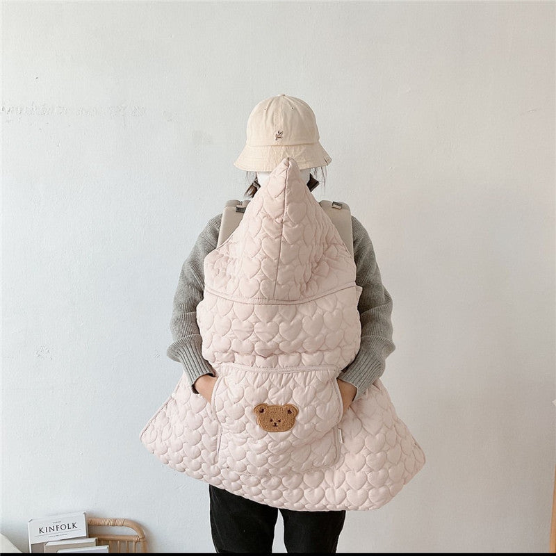 Squirrel face embroidered on the front pocket of the quilted baby cape