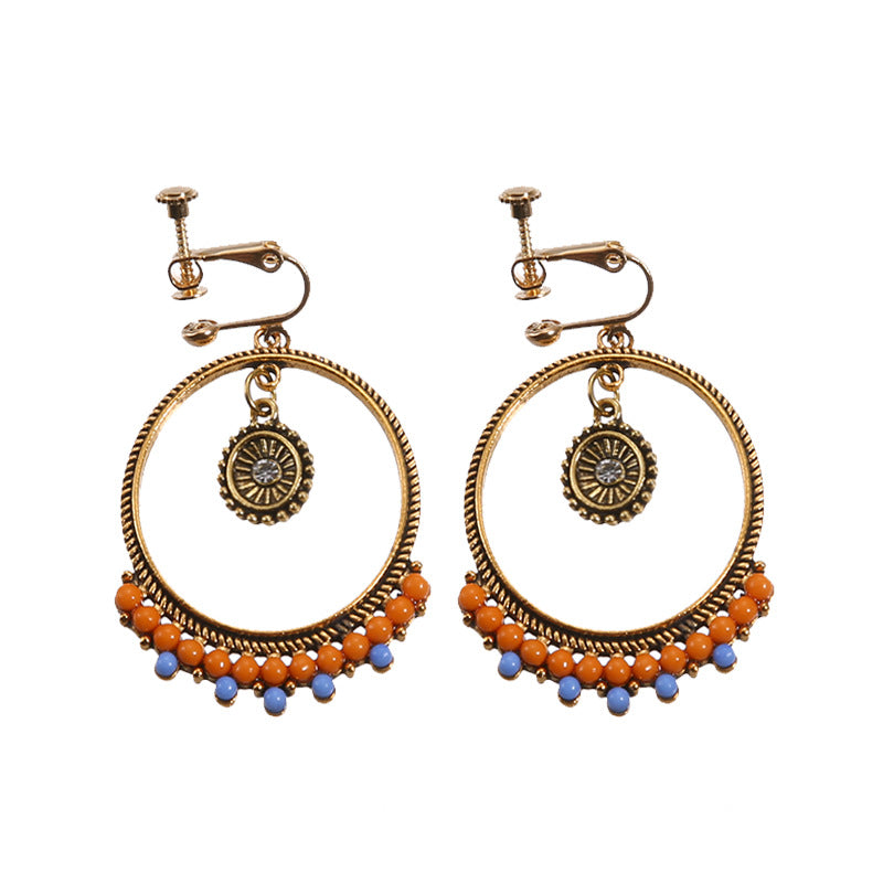 Vintage boho tassel clip-on earrings for non pierced ears, zinc alloy drop pair photographed on white background