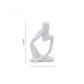 White abstract resin meditator figurine shown at about 13 cm tall against a plain background