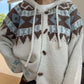 Close view of the brown and blue Fair Isle yoke, drawcords and horn-shaped buttons on a knit cardigan