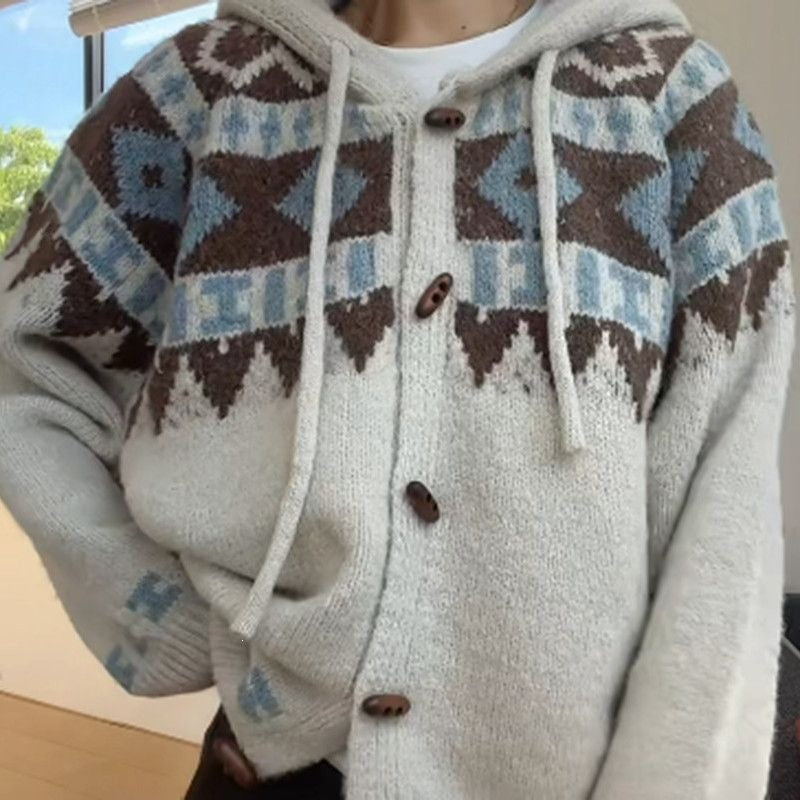 Close view of the brown and blue Fair Isle yoke, drawcords and horn-shaped buttons on a knit cardigan