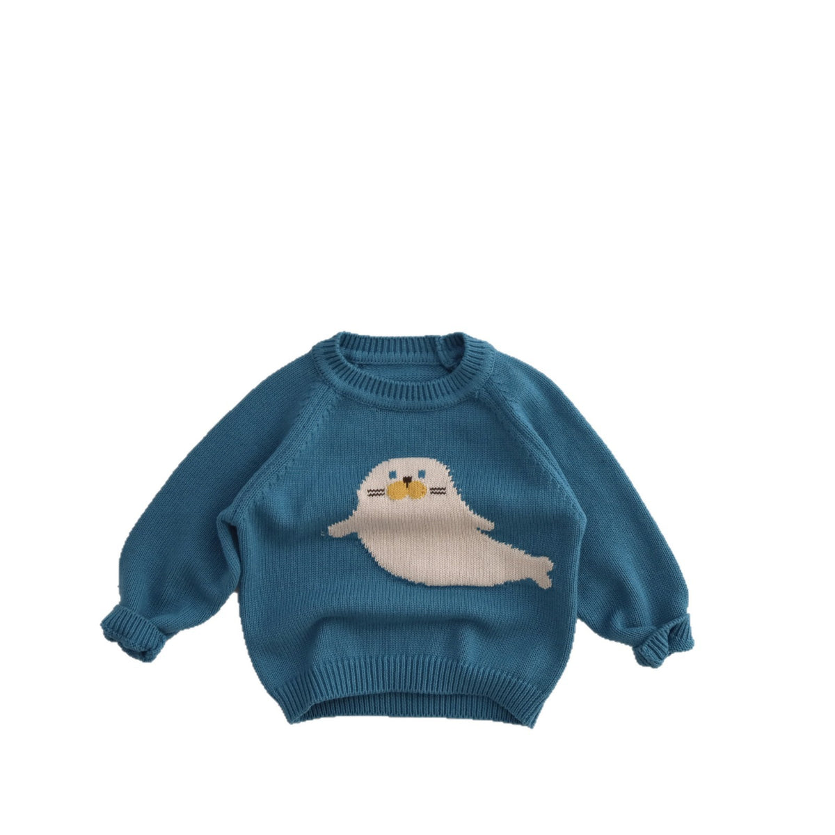 Blue cotton knit sweater with a cream seal motif and ribbed neck, cuffs and hem on white
