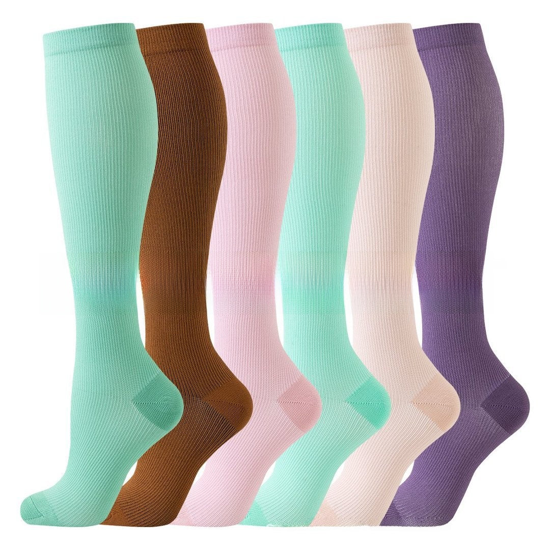 Knee high compression cycling socks with a ribbed cuff and textured sole