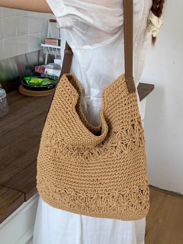 Khaki woven cotton shoulder bag carried by a woman in white