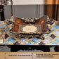 Footed European resin fruit plate with wood grain bowl, gilt scroll handles and pearl shell inlay center