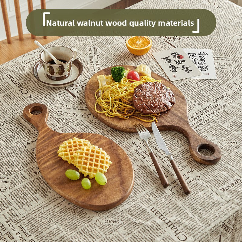 Walnut solid handle cutting board 30 by 20 cm shown from above with the grain visible