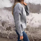 Side view of a gray ribbed knit cardigan with a patch pocket and long sleeves