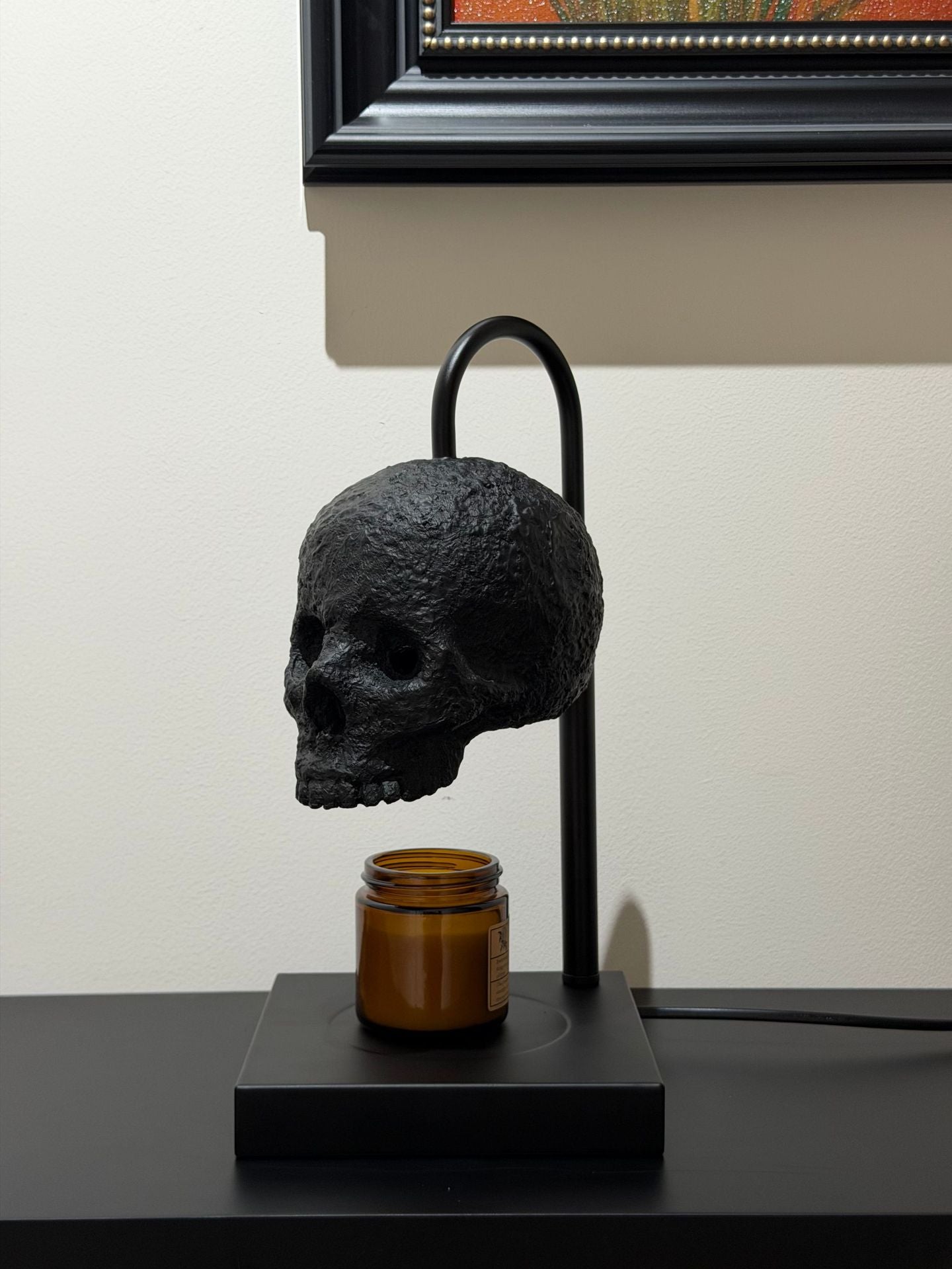 Four brightness views of the skull warmer at full and dimmed settings with the inline dimmer controller