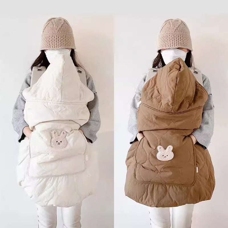Coffee colored quilted windproof cape over a baby carrier with animal pocket