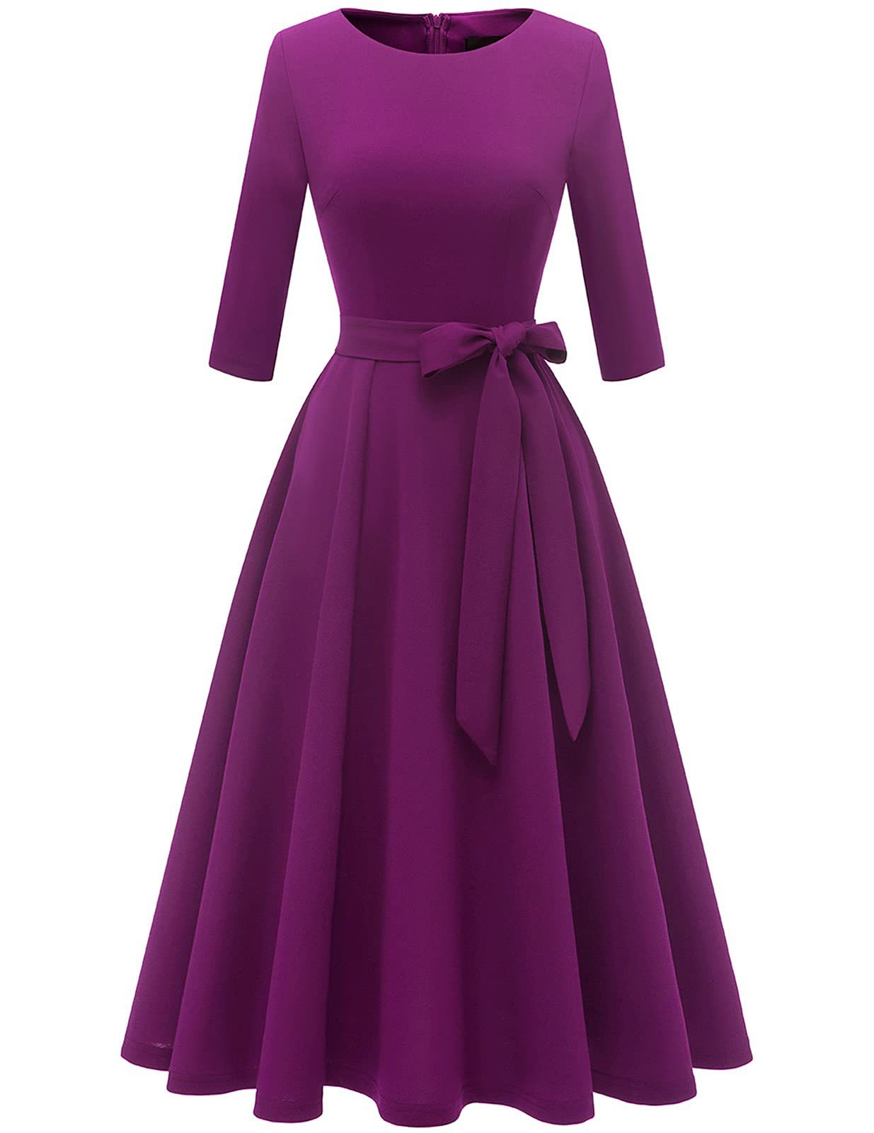 Pleated swing dress with tie belt photographed in a warm evening ambience setting