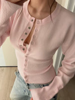 Pink French style rib knit cardigan buttoned to the hem, shown close up on a model