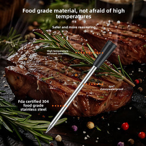 Stainless steel probe inserted into grilled steak with rosemary and pepper on a dark board