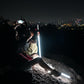 The LED trekking pole shaft lit up in bright white against a dark outdoor background