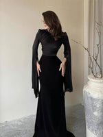 Slim-fit dress worn full length showing the defined waist and body-skimming line