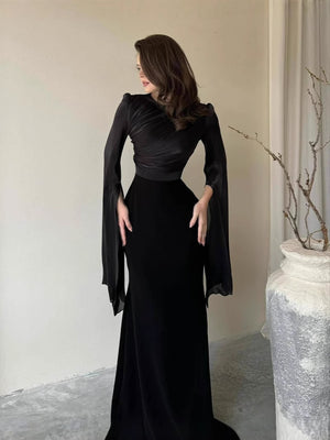 Slim-fit dress worn full length showing the defined waist and body-skimming line