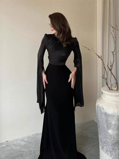Slim-fit dress worn full length showing the defined waist and body-skimming line