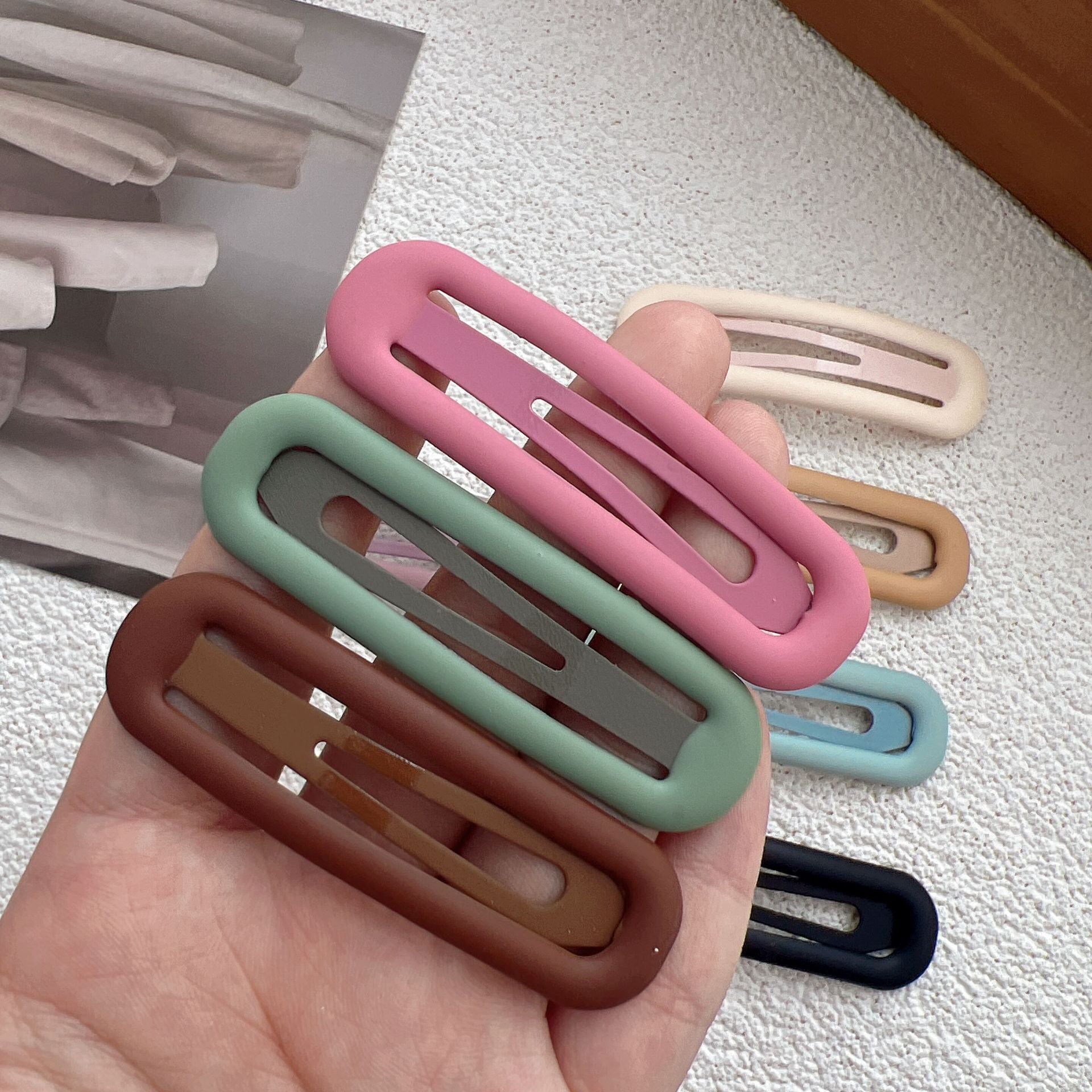 Rounded matte snap hair clip in a solid color