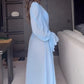 Side view of the floor length light blue chiffon robe showing sleeve drape and full length panels