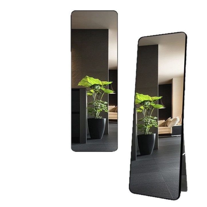 Black framed rectangular wall mirror leaning to show its slim rounded corner frame