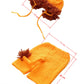 Flat lay of the orange knit lion bonnet and shorts with the sizes marked in centimeters