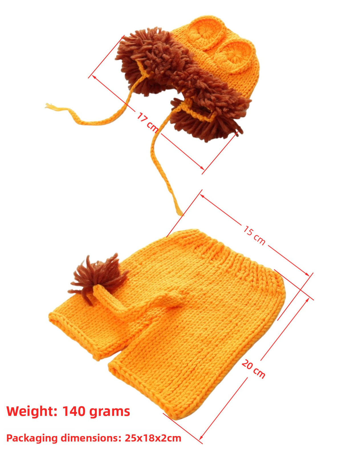 Flat lay of the orange knit lion bonnet and shorts with the sizes marked in centimeters