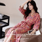 Angled view of the gauze bathrobe worn open over the shoulders at home