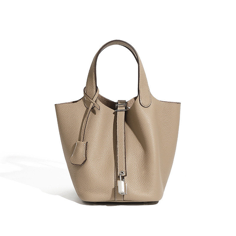Leather bucket tote bag styled in a modern interior setting
