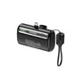 Black KTOYPWC capsule power bank with a fold-out Type-C plug, display and lanyard cable on a white background
