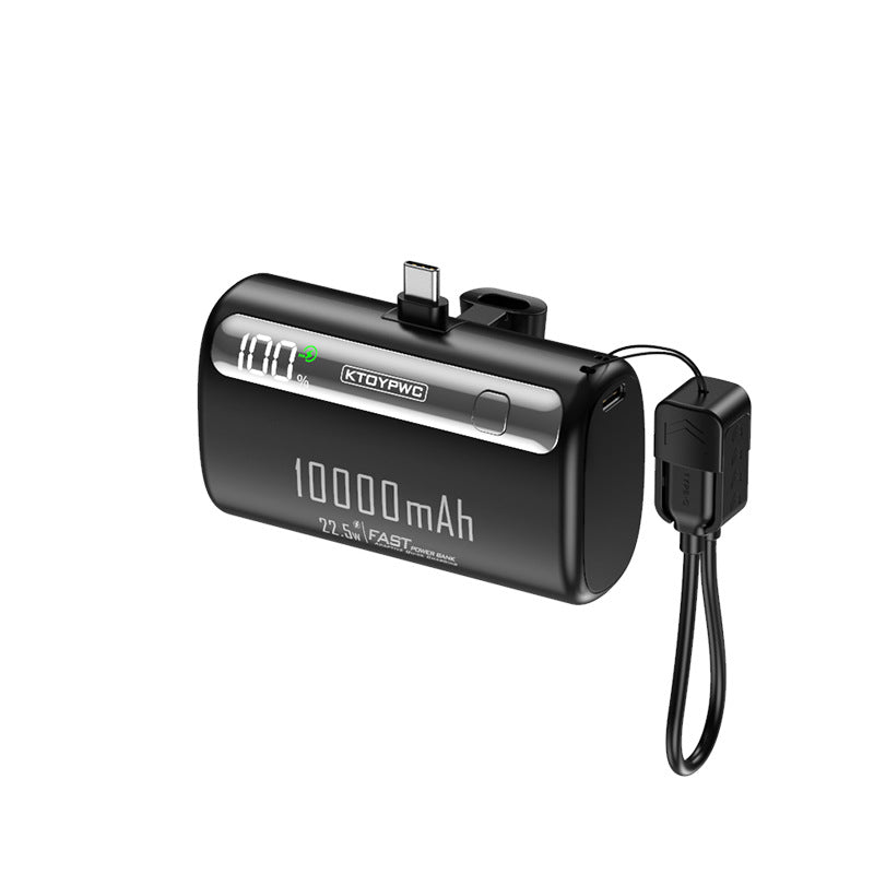 Black KTOYPWC capsule power bank with a fold-out Type-C plug, display and lanyard cable on a white background