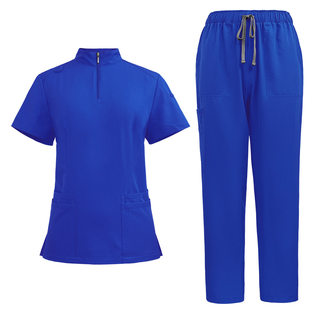 Womens scrub top in turquoise shown flat to display the stand collar, quarter zip and hip pockets
