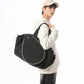 Man carrying the black racket-front sports bag on his shoulder by the top handles