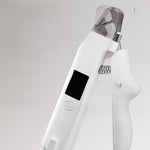 Closeup of white pet nail clipper head with clear guard, LED window and coil spring