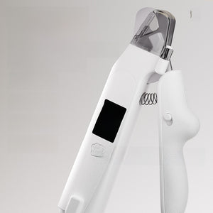 Closeup of white pet nail clipper head with clear guard, LED window and coil spring