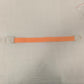 Single orange elastic quick release tourniquet band with a white snap buckle laid flat