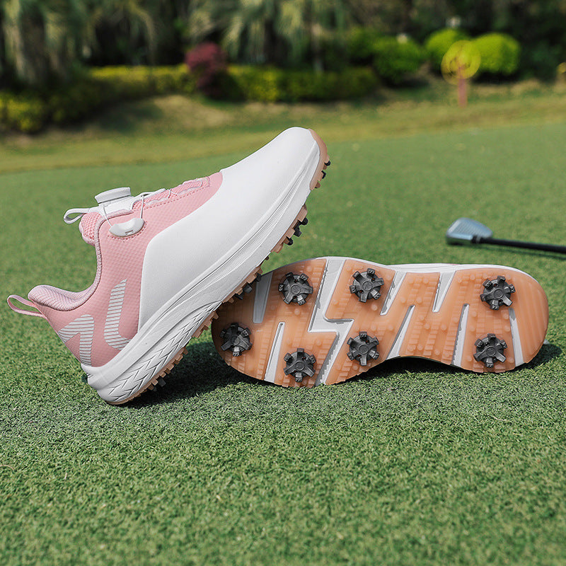 White and pink golf shoe with a twist dial closure and a spiked star cleat outsole