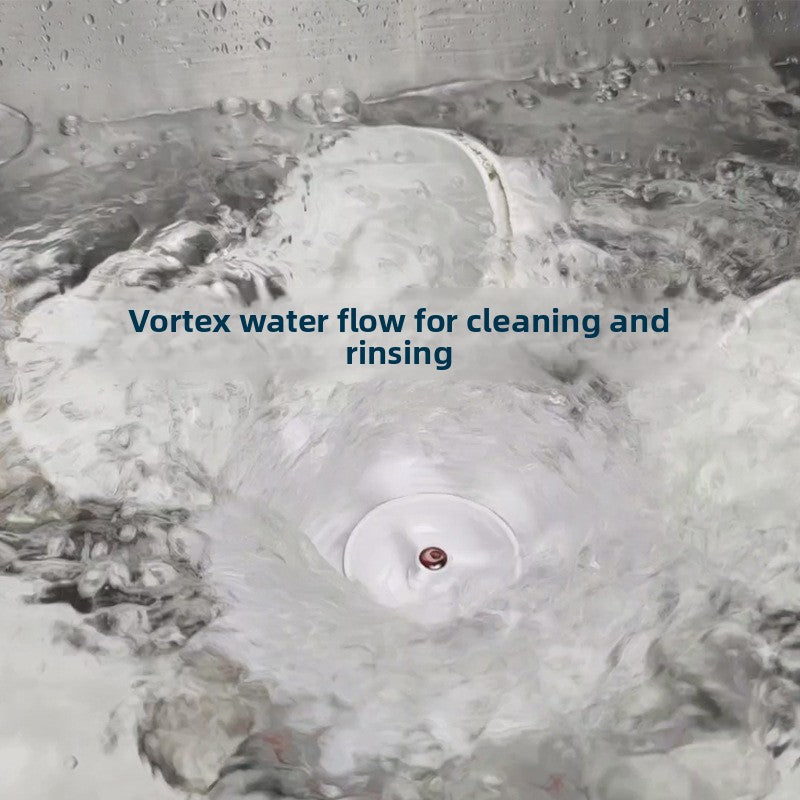 Whirlpool of water around the vortex dishwasher disc in a stainless steel sink with plates, vortex flow caption