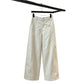 Ecru wide leg trousers on a hanger with the wide leg spread open