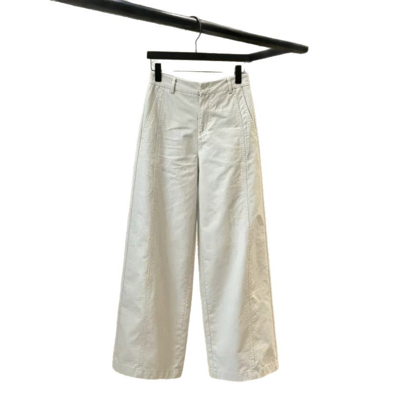 Ecru wide leg trousers on a hanger with the wide leg spread open