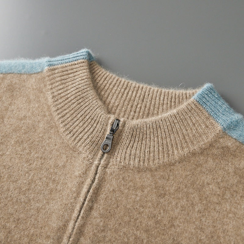 Close view of a ribbed collar and metal zipper pull on a camel wool cardigan with light blue trim