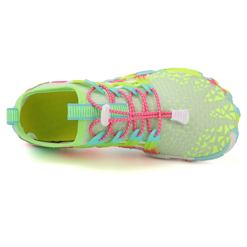 A black and rose red rubber drainage outsole of a barefoot water shoe with deep grip lugs
