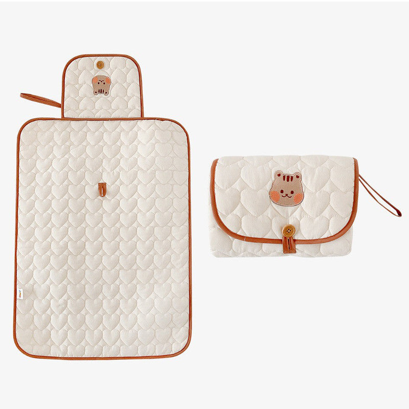 Quilted cotton changing pad shown folded with its design options overview