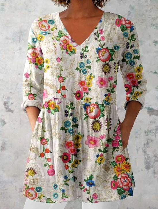 Printed empire peplum tunic top worn loose with three quarter sleeves