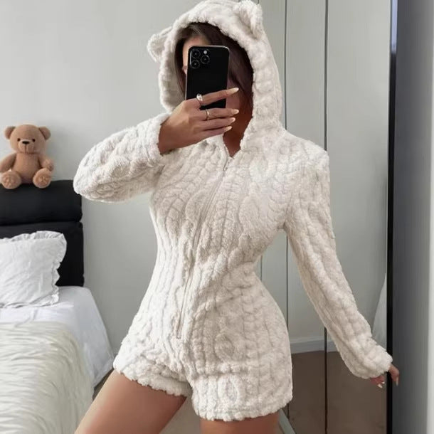 Front view of the white plush hooded romper with front zip and bear ears, worn for a mirror photo